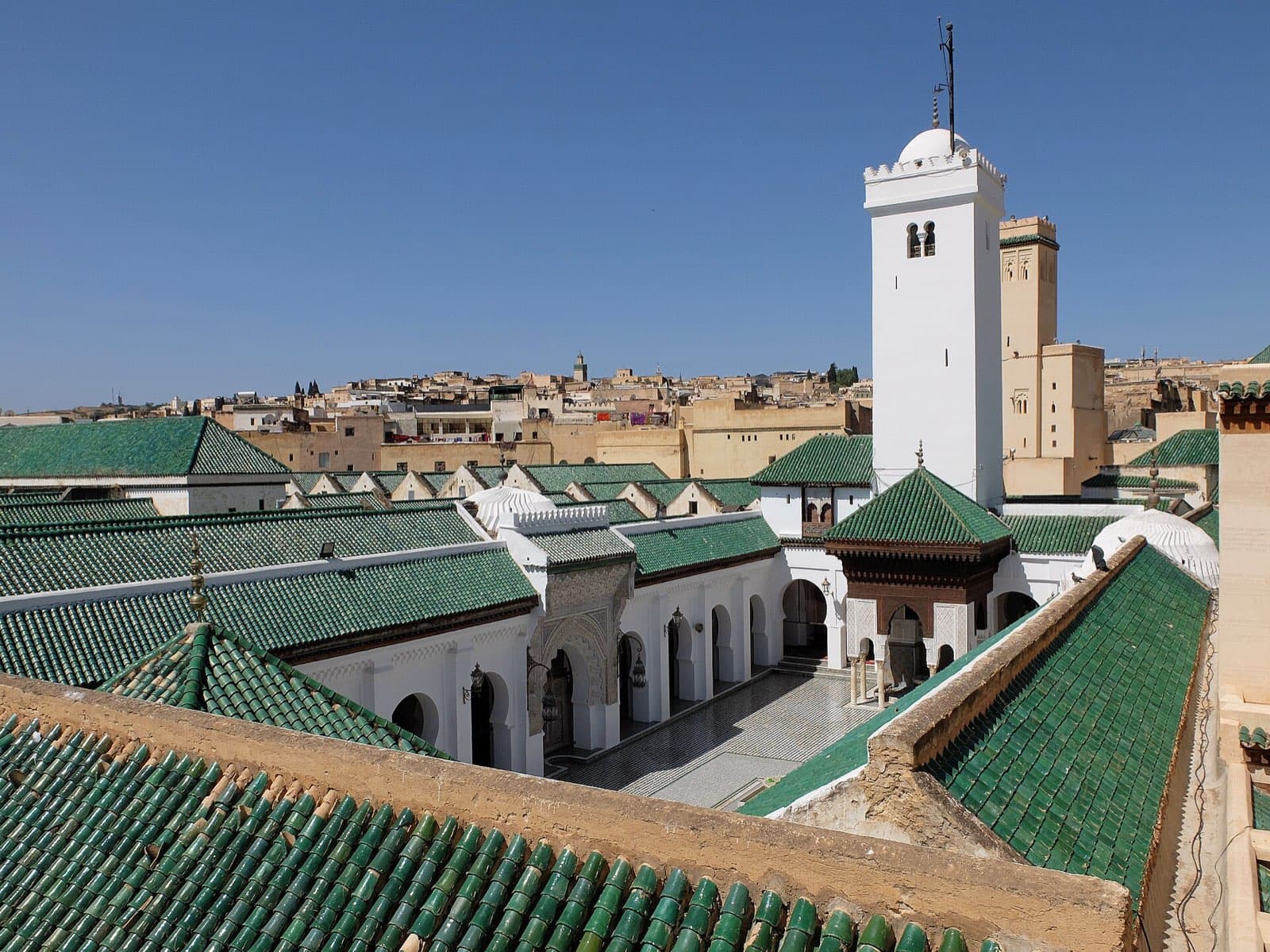 Green-tiled roofs and the white minaret of the Qarawiyyin